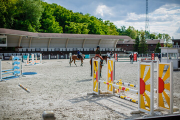 Show jumping arena with obstacles, barriers and poles, horse riding, equestrian sport and horses concept, competition field, background wallpaper 