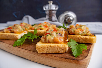 Sandwiches with guacamole and salsa on a wooden board on a white background. 