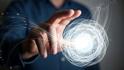 A hand interacts with a bright, swirling ball of light, suggesting energy or technology