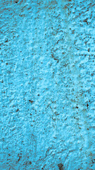 wall with old blue paint peeling off