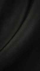 black crinkled material with visible details. background