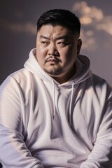 Fototapeta premium Portrait of a man wearing a white hoodie with a serious expression
