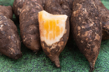 Fresh yacon roots in the market background