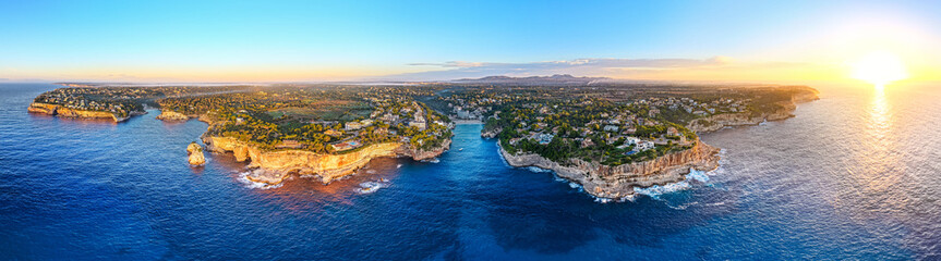 Aerial View of Cala Santany&iacute;: Turquoise Cove and Beach Resort on Mallorca's Mediterranean Coast
