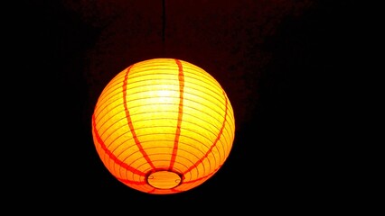 Warm yellow lantern light creating a cozy night atmosphere.
