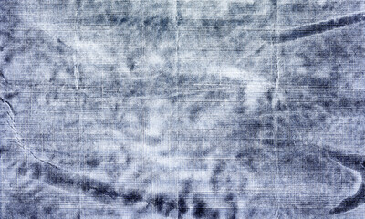 Close up of a textured blue and white fabric with visible folds and a slightly blurred appearance