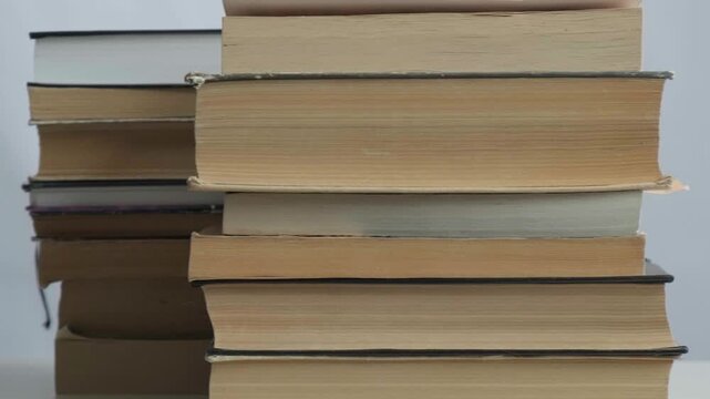 Close-up and macro shot many old books in school library or vintage bookshop. Education literature, research, archive collection and historical knowledge. Reading, studying for university students