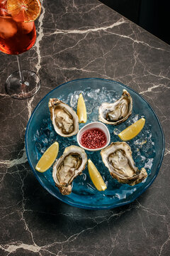 fresh galician raw oysters on ice in gourmet vigo restaurant table in spain
