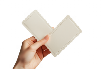 Hand holding blank cream cards isolated on a transparent background