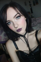 Fototapeta premium Young Gothic Emo Woman in Black Leather Corset with Dramatic Makeup