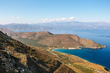 Beautiful Crete coastline with blue sea and rocky hills in summer.