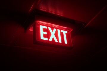 Illuminated red exit sign glowing in the darkness shows the way out, concept for emergency escape, safety guidelines and evacuation plan