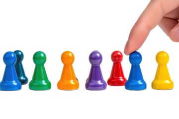 Colorful game pieces are skillfully arranged and selected by a finger in a bright setting during an indoor game activity