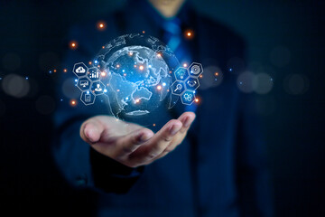 Businessman holding digital globe with virtual icons, representing global business network, data analytics, and technology innovation for worldwide connection and digital transformation concept.
