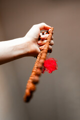 Japamala from Rudraksha on the hand. Prayer beads. Religious equipment	
