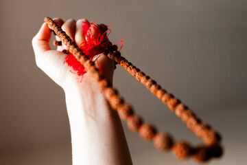 Japamala from Rudraksha on the hand. Prayer beads. Religious equipment	
