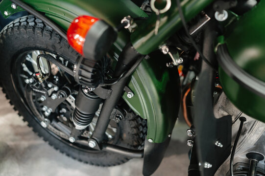 detailed view of retro motorcycle sidecar wheel with gleaming chrome and artistic lighting