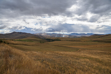 Scenic autumn landmark with field and mountains, Armenia