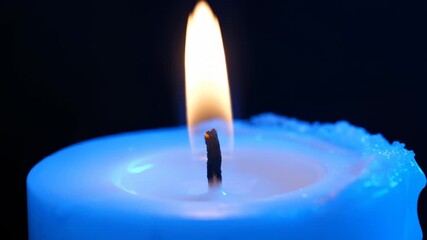 Candle Flame Flickering on a Blue Candle in the Dark - Powered by Adobe