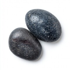 Two polished, smooth black stones, showcasing natural beauty and textures. The stones have a striking appearance and a tactile, inviting quality.