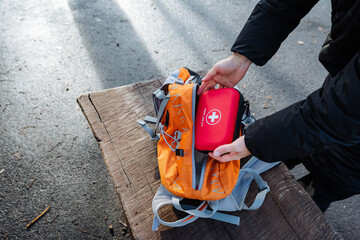 Unpacking emergency kit roadside, Cyclist retrieves first aid kit for injury treatment, Rider...