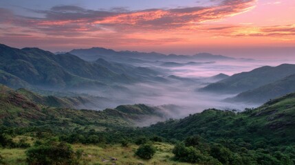 Fototapeta premium Serene Mountain Landscape at Sunrise with Misty Valleys and Colorful Sky Reflections in Early Morning Light Overlooking Lush Green Hills