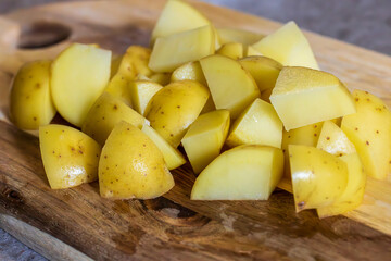 Cut the potatoes into chunks and prepare for the cooking steps.