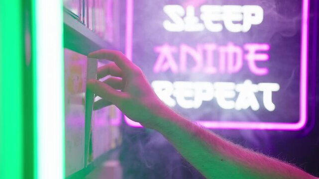 Hand pick a manga comic from shelf with futuristic neon sign in background 4K