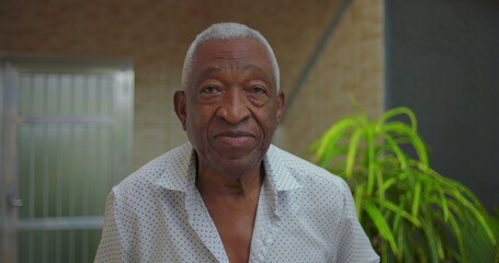 Elderly African American man looking directly at the camera with a calm and composed expression,...