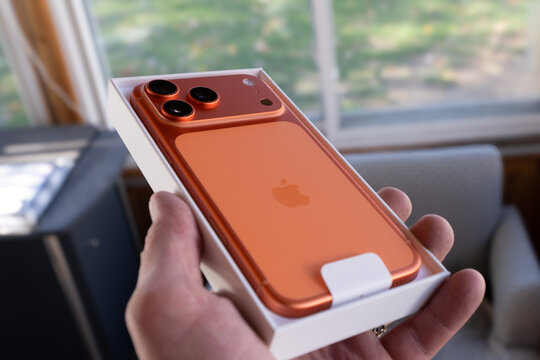 Iphone 17 Pro Max in cosmic orange is new and in packaging illustrating the sleek new design, color and new camera configuration of the latest model