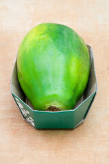 a papaya in a cardboard container