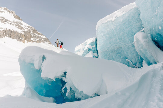 A group of skiers explore the large ice caves in the Northern Rockies of British Columbia, Canada.