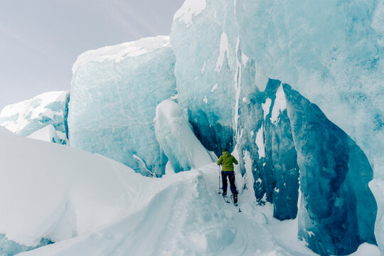 A group of skiers explore the large ice caves in the Northern Rockies of British Columbia, Canada.