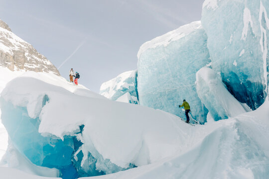 A group of skiers explore the large ice caves in the Northern Rockies of British Columbia, Canada.