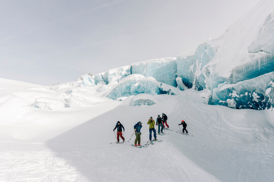 A group of skiers explore the large ice caves in the Northern Rockies of British Columbia, Canada.