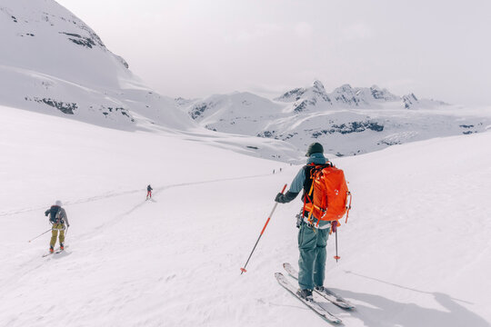 Skiers enjoy a backcountry tour in the Northern Rockies of British Columbia, Canada.