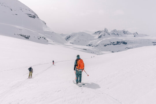 Skiers enjoy a backcountry tour in the Northern Rockies of British Columbia, Canada.