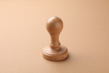 One wooden stamp on brown background, closeup