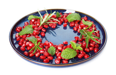 Christmas food. Pomegranate seeds, mint and rosemary isolated on white