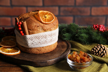 Christmas food. Delicious Panettone cake, ingredients and festive decor on wooden table, closeup