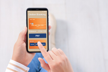 Online payment. Woman using banking app on smartphone indoors, closeup