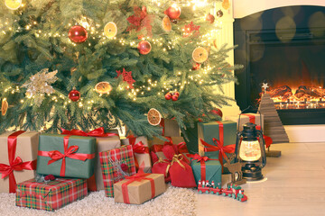 Christmas tree and gift boxes in room. Bokeh lights. Greeting card design