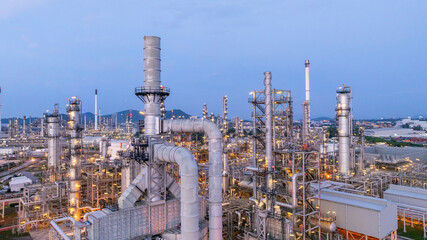 Aerial view oil and gas refinery plant at night, Oil and gas industrial petrochemical fuel power and energy at industry zone, Oil and gas refinery industrial energy supply chain.