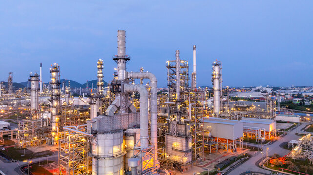 Aerial view oil and gas refinery plant at night, Oil and gas industrial petrochemical fuel power and energy at industry zone, Oil and gas refinery industrial energy supply chain.