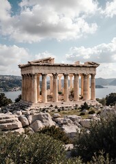 Fototapeta premium Ancient greek temple ruins with dramatic sky and scenic landscape in background