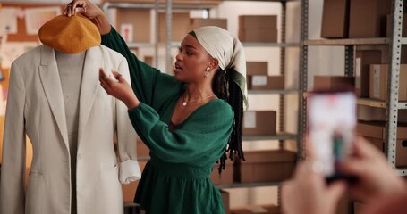 Recording, woman and stylist influencer with clothes for live streaming review with ecommerce business. Boxes, vlogging and content creator with fashion jacket for outfit ideas online in workshop.