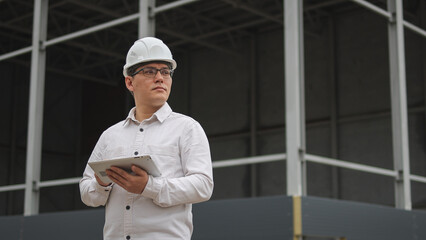 Engineer at a construction site. An ambitious project. High-quality photo.
