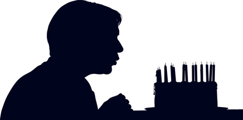Silhouette of a person blowing out candles on a birthday cake