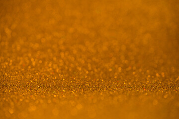 Golden glitter bokeh background with shallow depth of field and sparkling texture, perfect for festive design, luxury branding, and celebration themes. Photo