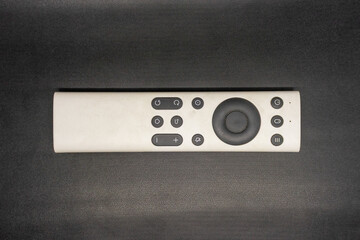 Minimalist White Remote Control on Dark Background